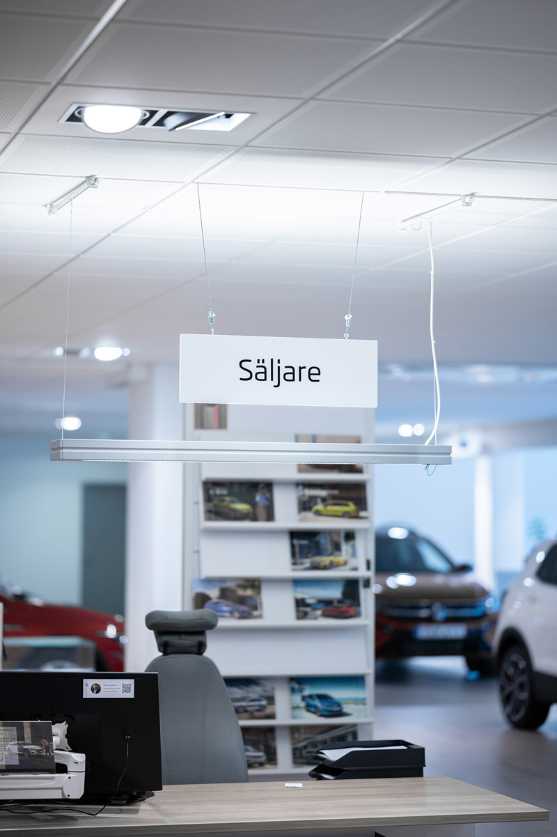 Sales floor at a car dealership with a sales sign